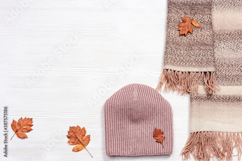 Autumn flat lay with warm woolen scarf and knitted cap. Fashion autumn clothes