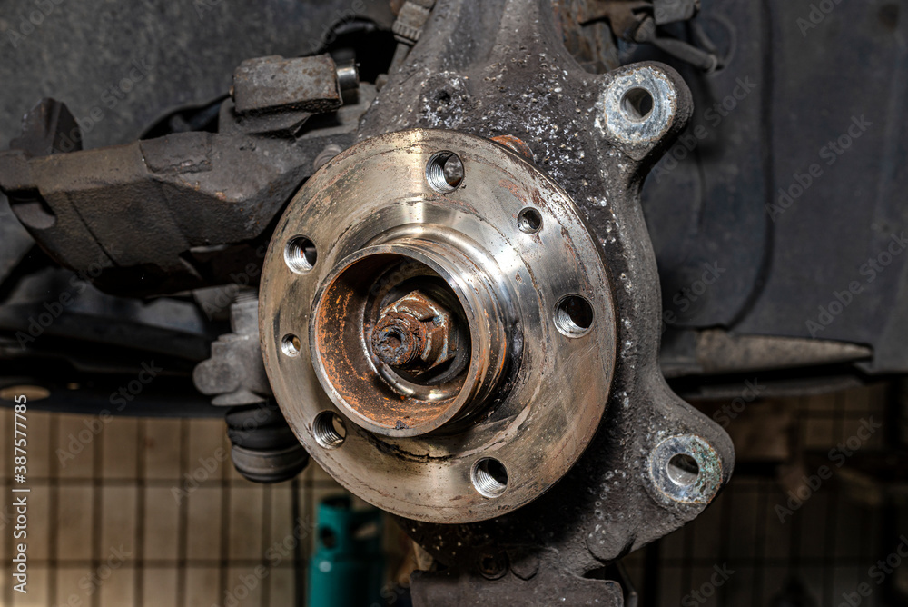 New front hub mounted in a car on a steering knuckle without a brake disc. New front hub mounted in a car on a steering knuckle without a brake disc.