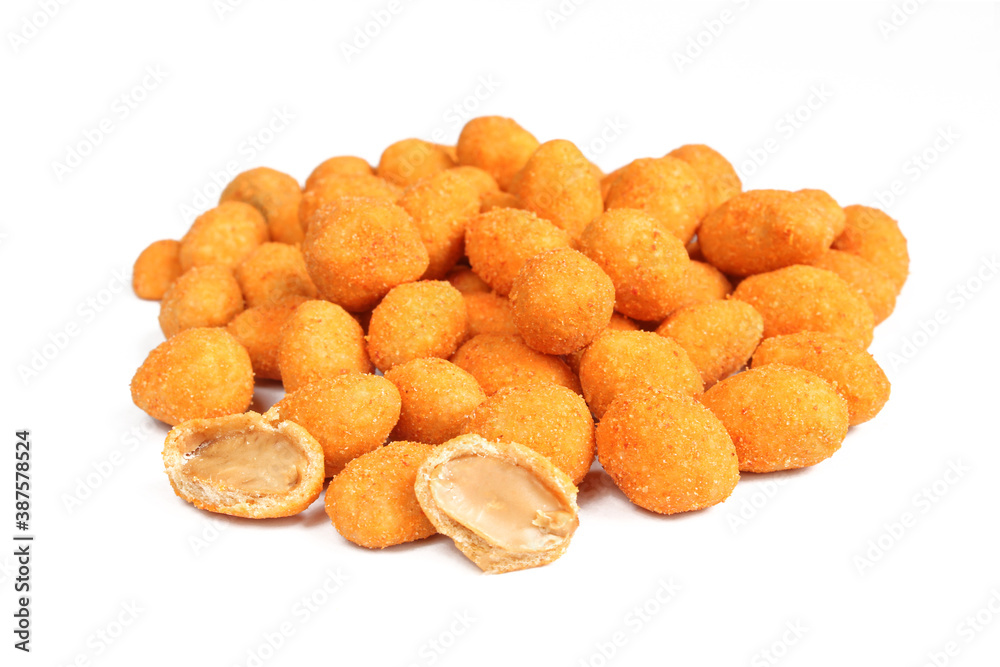 Peanuts covered with chili paprika seasoning. Pile of salty appetizer isolated on white background Peanuts covered with chili paprika seasoning. Pile of salty appetizer isolated on white background
