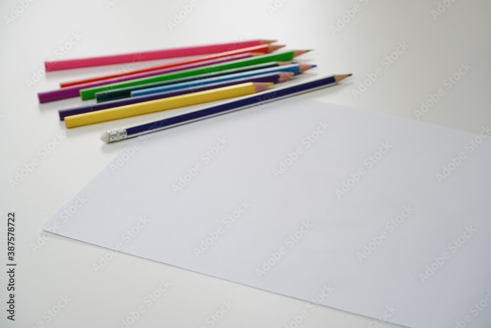 Kid hands with pencil writing in a white empty paper, child drawing, Education and children activities, copy space