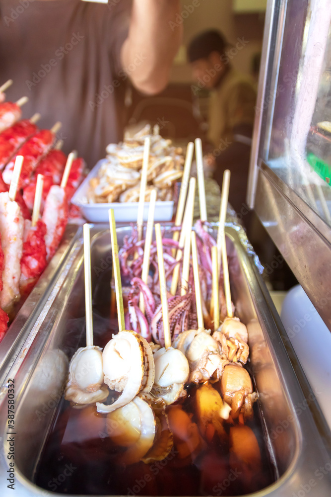Scallops, octopus and crab,  usually served on wooden skewers popular street food in Arashiyama, Kyoto, Japan.