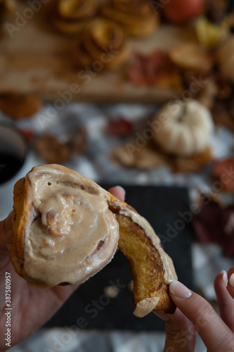 hand holding a cinnamon roll