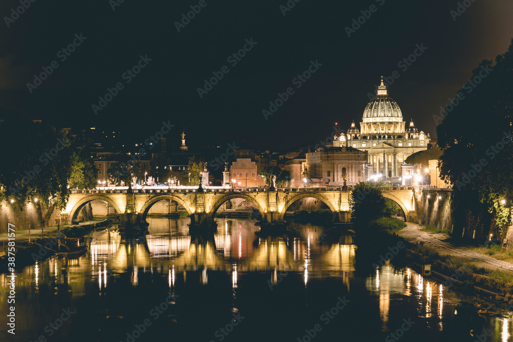 View of Rome at night from a bridge.