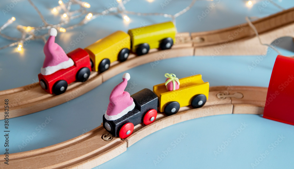 Preparing for New Years: a toy train in a Santa hat delivers Christmas gifts