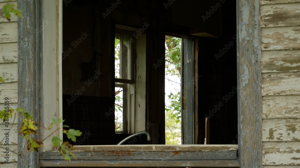 Old abandoned farmhouse open window