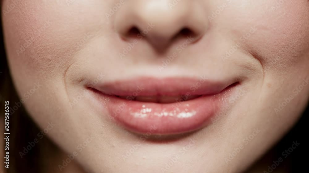 Cute girl lips making smile in studio. Beautiful woman mouth smiling in atelier Cute girl lips making smile in studio. Beautiful woman mouth smiling in atelier