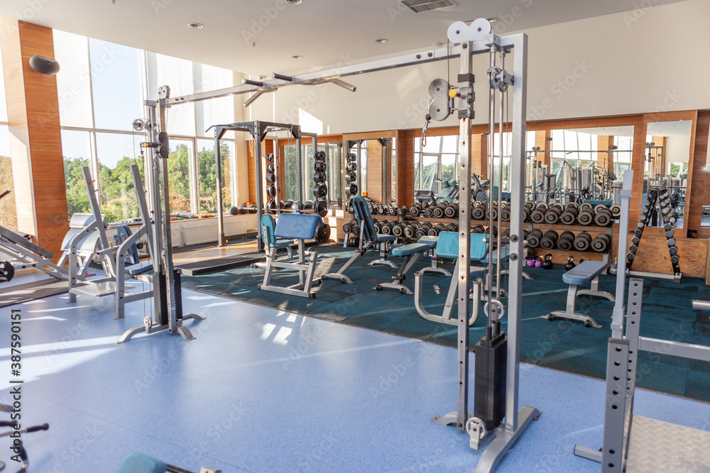 Interior of modern gym fitness room with exercise machines