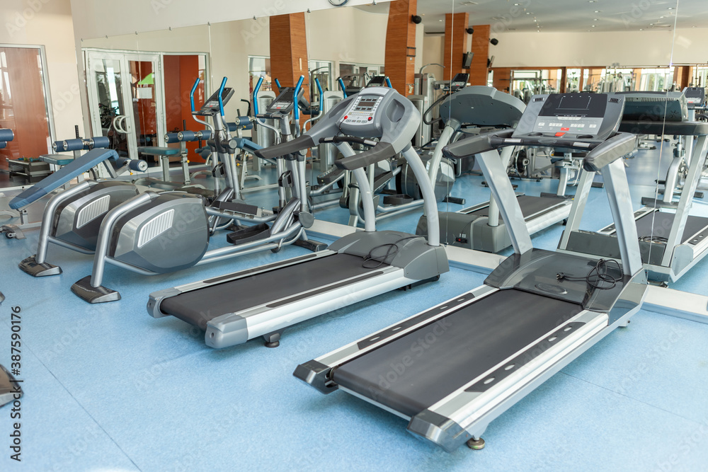 Interior of modern gym fitness room with treadmills Interior of modern gym fitness room with treadmills