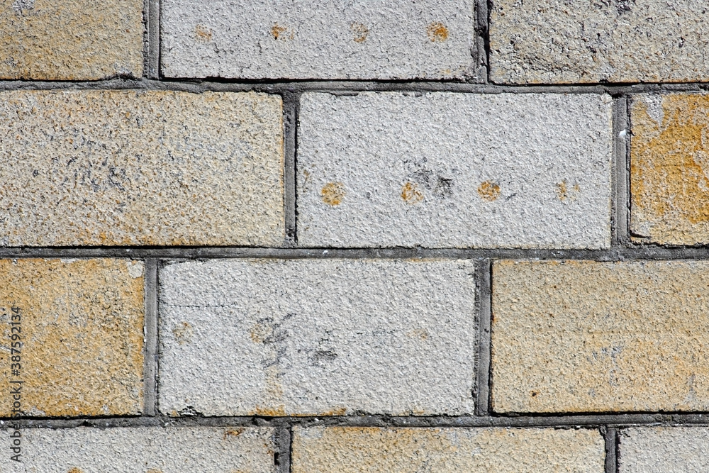 Fototapeta premium The white and yellow brick wall closeup