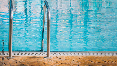 Closed plan of a pool ladder with the pool in the background.