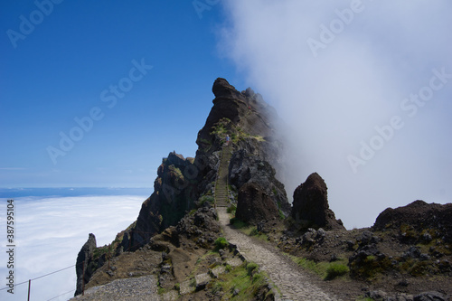 Stunning view of clouds partly covering a mountain on the way from Pico Ruivo to Pico Arieiro in Madeira, Portugal