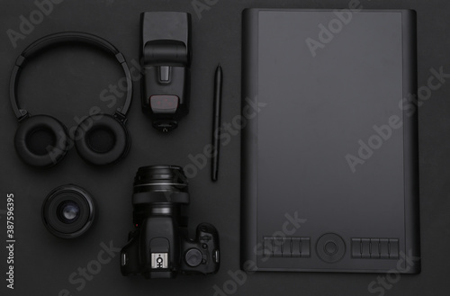 Photographer retouching equipment on black background. Top view. Flat lay