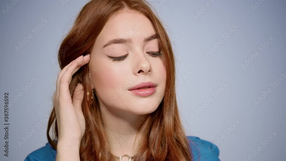 Pretty girl flirting in studio in slow motion. Woman touching face indoors Pretty girl flirting in studio in slow motion. Woman touching face indoors