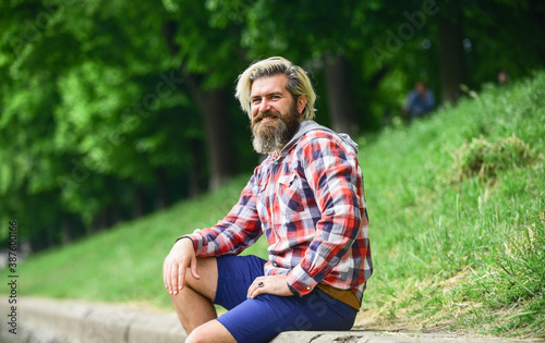 Bearded hipster relax outdoors. Man tourist sit riverside. Man with beard and moustache relaxing nature background. Tourism concept. Summer vacation. Nice day. Rest and relax. Relaxation and pleasure