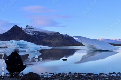 Man taking a picture of Jokulsarlon Lake in Iceland