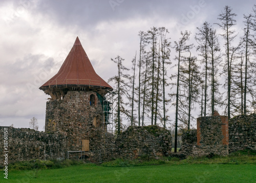 landscape with castle ruins, autumn day, restored tower roof, Ergeme castle ruins in autumn photo