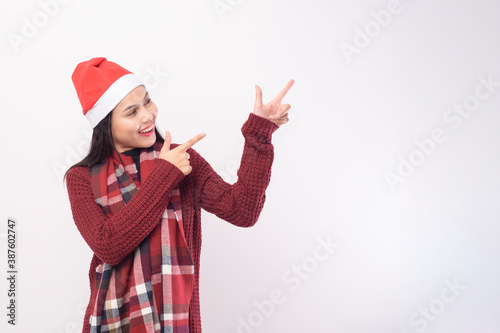 Portrait of young smiling woman wearing red Santa Claus hat isolated white background studio.