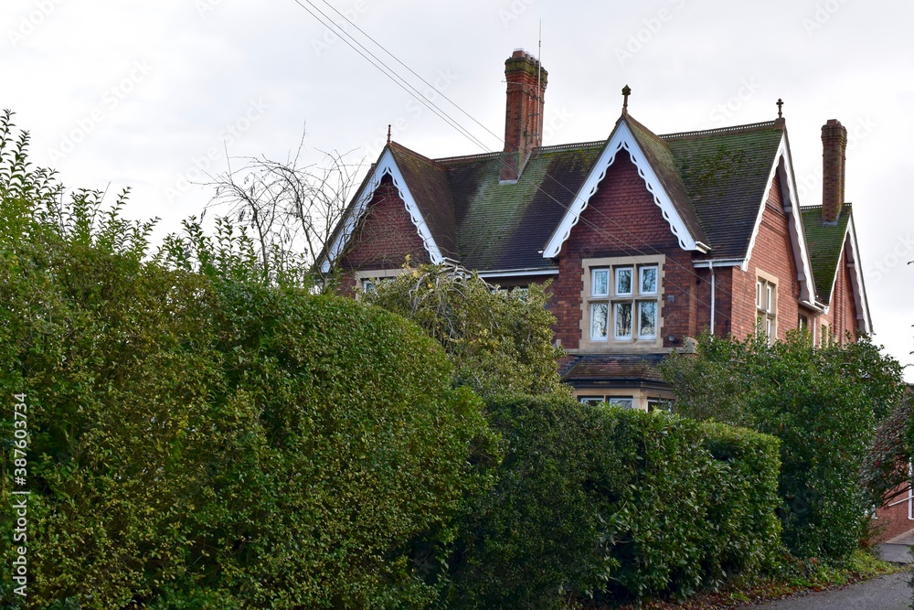 Rural house behind the hedge, England, UK Rural house behind the hedge, England, UK