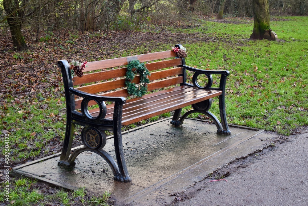 Memorial bench in park decorated for Christmas, Coventry, England