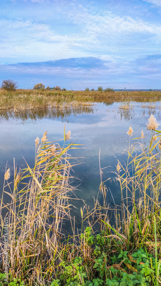 Sunny day on the perfect lake. Autumn lake with reflection on the water. Cloudy sky in the sunny day. Sunny day on the perfect lake. Autumn lake with reflection on the water. Cloudy sky in the sunny day.