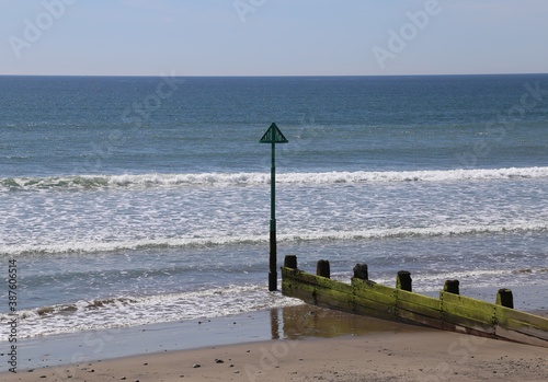 A safety groyne marker on the beach in Tywyn, Gwynedd, Wales, UK. photo