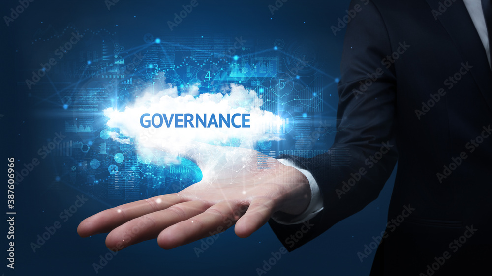 Hand of Businessman holding GOVERNANCE inscription, successful business concept Hand of Businessman holding GOVERNANCE inscription, successful business concept