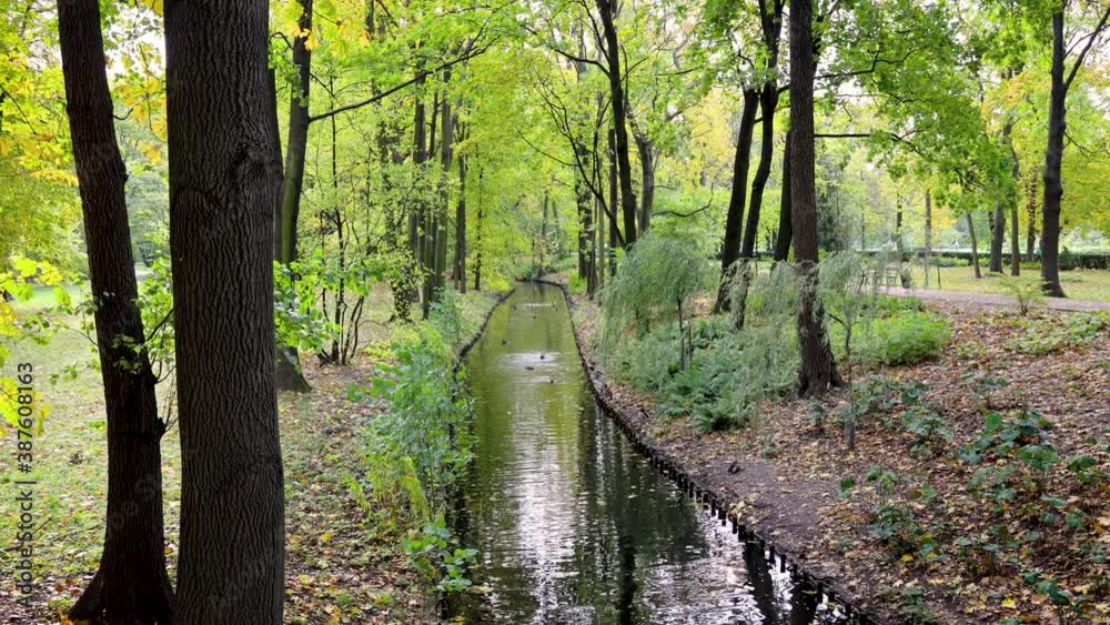 Water canal during autumn in Lazienki Krolweskie, Royal Baths Park in Warsaw city, Poland, 4k footage Water canal during autumn in Lazienki Krolweskie, Royal Baths Park in Warsaw city, Poland, 4k footage