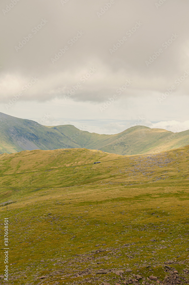 Fototapeta premium View from Ranger Path at Llanberis Path with a mountain train route to the Yr Wyddfa peak - foreland of Snowdon. Highest mountain range in Wales.