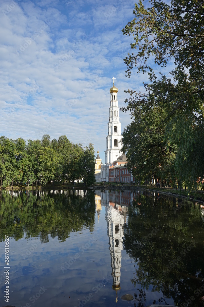 the bell tower of the monastery is reflected in the pond the bell tower of the monastery is reflected in the pond