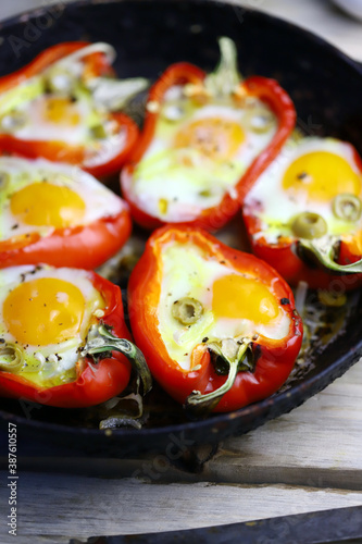Selective focus. Red peppers with egg, baked in a pan. Healthy food. Autumn lunch.