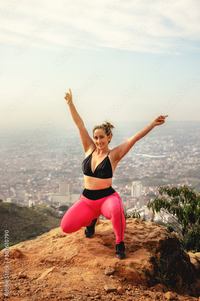 young sportsman celebrating after hard training on the background of mountains young sportsman celebrating after hard training on the background of mountains