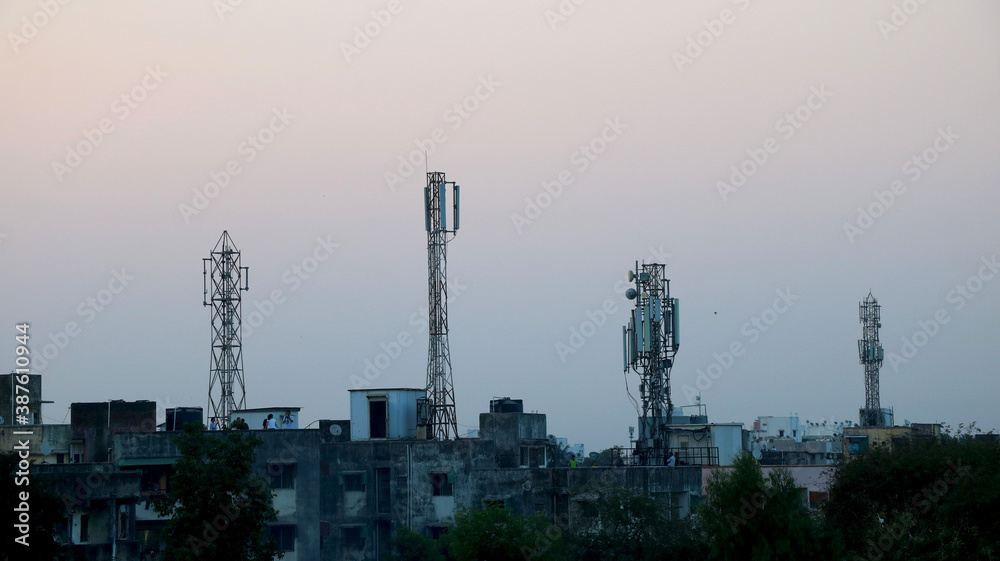 Four telecommunication tower on top of building terrace