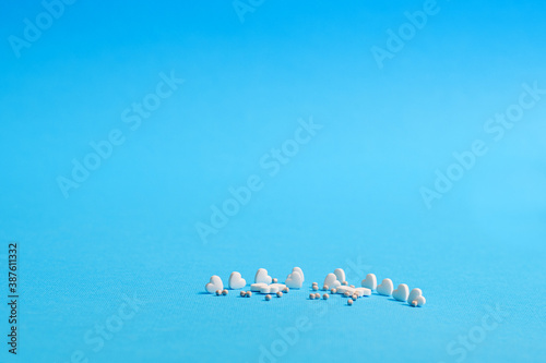 White and colored medicines in the form of figurines.