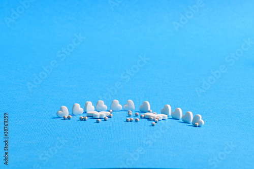 White and colored medicines in the form of figurines.