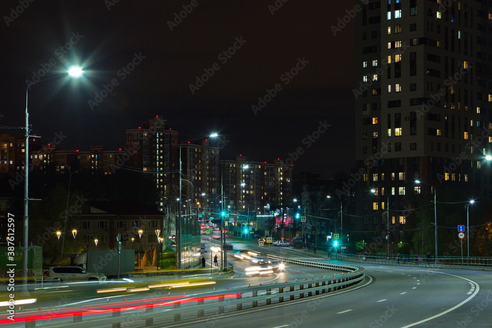 Fototapeta premium The streets of the night city in the lights of passing cars.