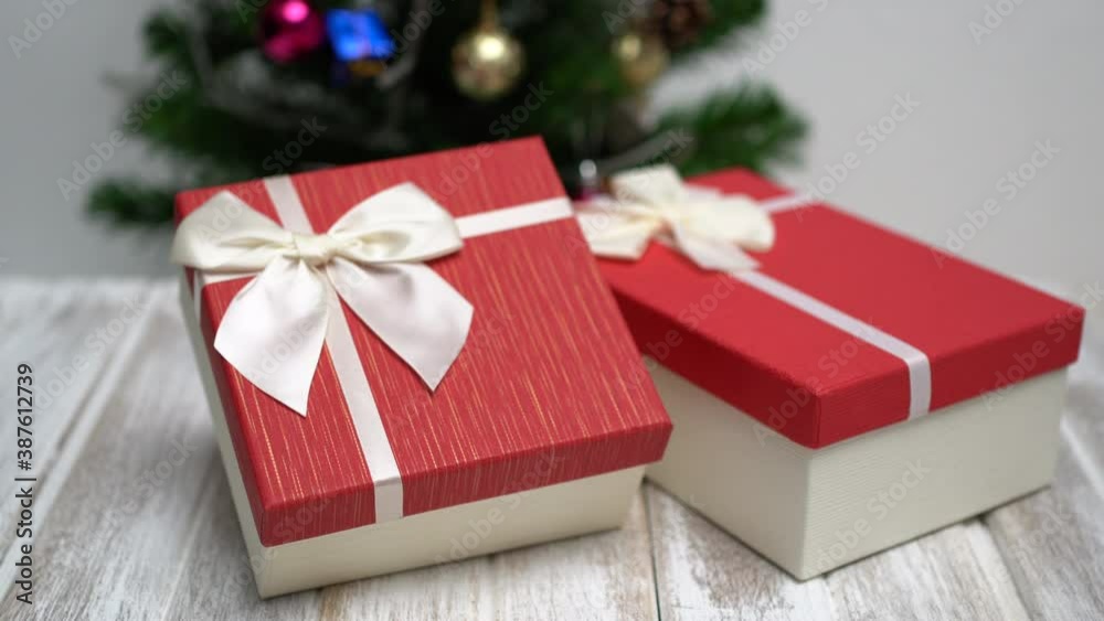 New Year and Christmas presents. Gifts in bright boxes with a bow under a Christmas tree. Dark room with christmas and new year interior decoration. New Year and Christmas presents. Gifts in bright boxes with a bow under a Christmas tree. Dark room with christmas and new year interior decoration.