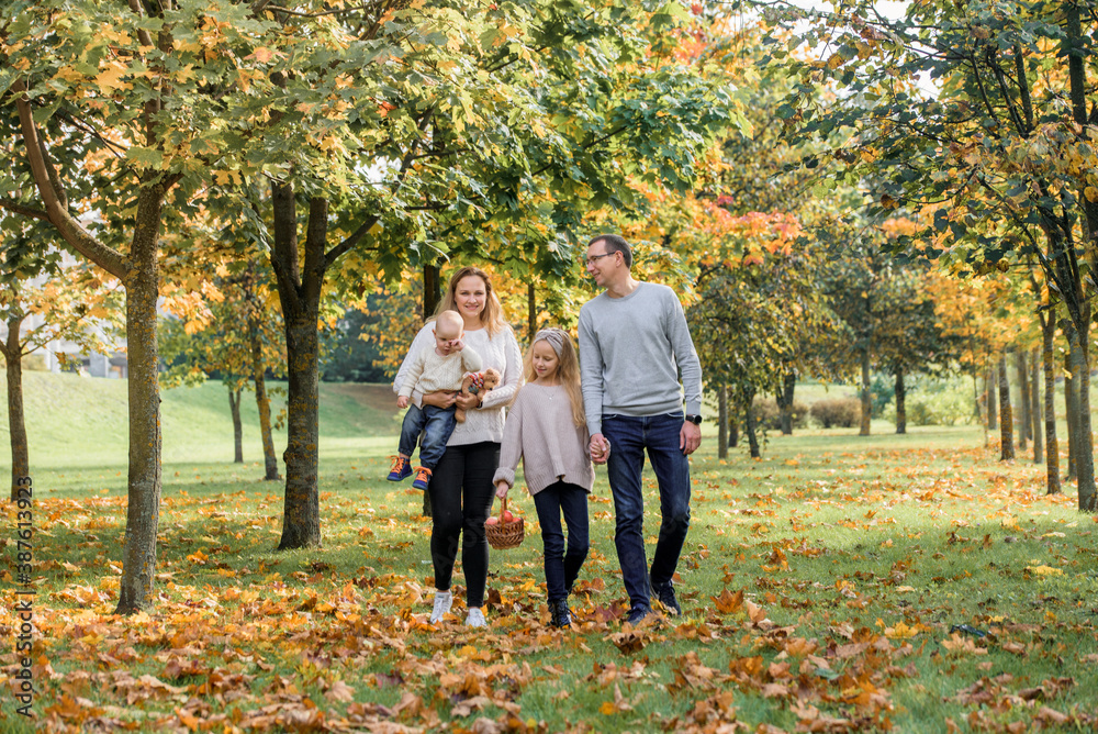 Happy family relaxing outdoors In autumn park.leaf fall, lifestyle. Happy family relaxing outdoors In autumn park.leaf fall, lifestyle.