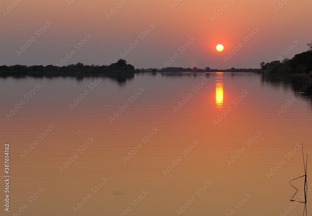 A golden sunset over the waters of the Thamalakane River in Botswana