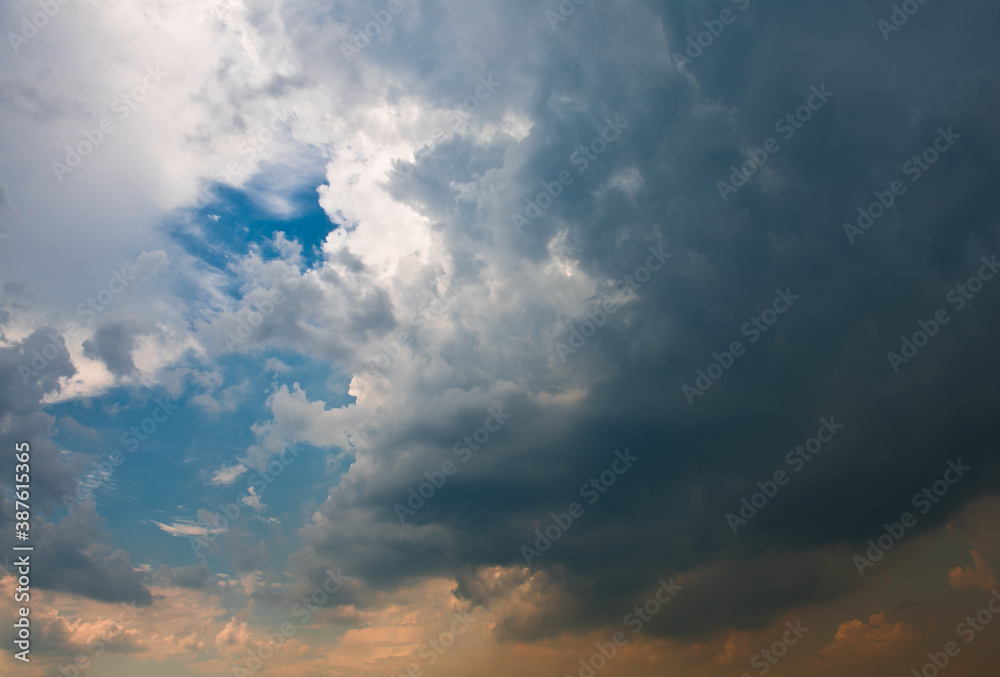 Fototapeta premium Yellow and black clouds in the sunset sky