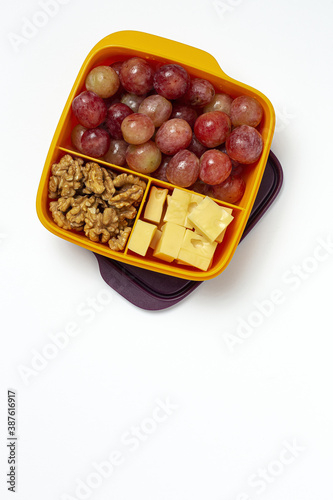 Food in Plastic containers ready to eat with Cheese, grapes and nuts