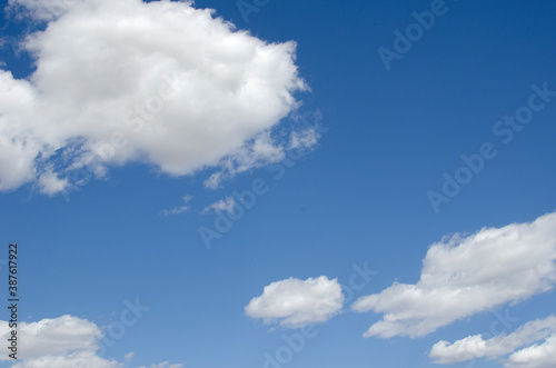 White clouds on a blue sky. Background. © Anatolii