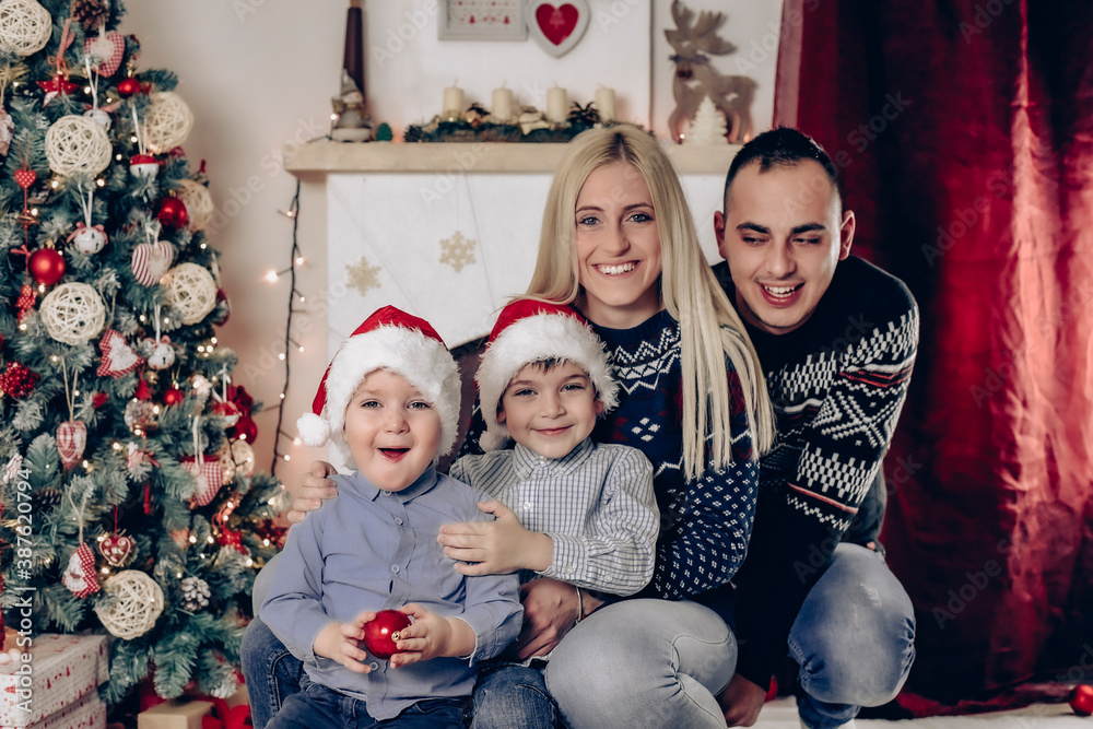 Mother, father and kids celebrate Christmas - family photo