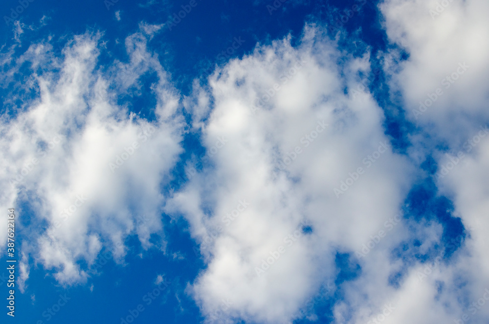 Obraz premium White clouds on a blue sky. Background.