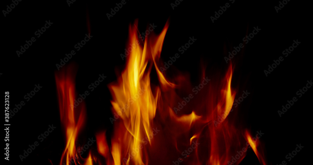 Soft blurred orange flames against black background with copy space