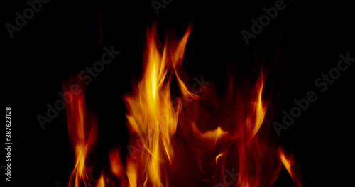 Soft blurred orange flames against black background with copy space