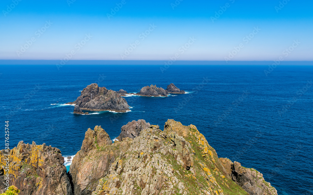 View of Aguillons rocks or islands emerging from the ocean at Cape Ortegal in the Galicia region of Spain.
