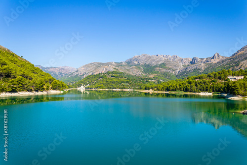 Guadalest swamp on a sunny day with reflections in the water. © Pablo Eskuder