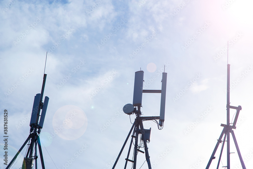 Large antennas against the sky. Antennas on the roof of the building. Large antennas against the sky. Antennas on the roof of the building.