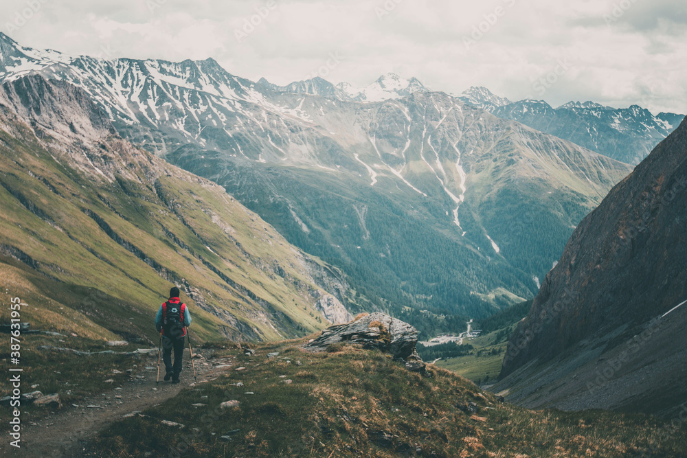 A man hiking in austrian mountains around Grossglockner - wide shot.