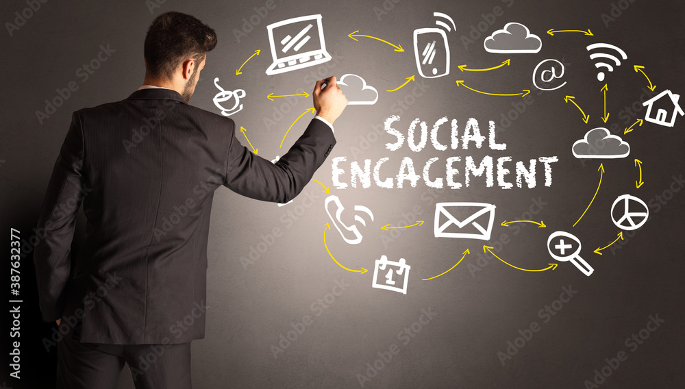 businessman drawing social media icons with SOCIAL ENGAGEMENT inscription, new media concept businessman drawing social media icons with SOCIAL ENGAGEMENT inscription, new media concept